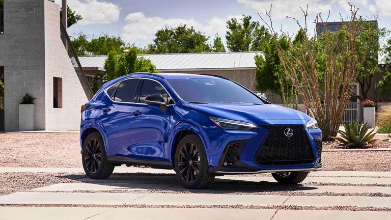 2024 Lexus NX 450h+ parked in front of a driveway.